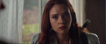 Movie still from “Black Widow” (2021), directed by Cate Shortland – A person with long red hair; Close Up shot, Over the shoulder angle