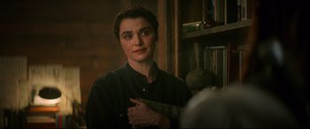 Movie still from “Black Widow” (2021), directed by Cate Shortland – A woman standing in front of a mirror in a room; Close Up shot, Over the shoulder angle