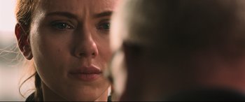 Movie still from “Black Widow” (2021), directed by Cate Shortland – A woman's face looking into a mirror; Close Up shot, Over the shoulder angle