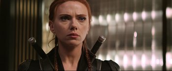 Movie still from “Black Widow” (2021), directed by Cate Shortland – A person holding a weapon; Close Up shot, Over the shoulder angle