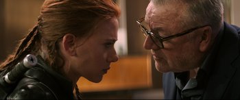 Movie still from “Black Widow” (2021), directed by Cate Shortland – An older man and a younger woman face to face; Close Up shot, Over the shoulder angle