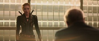 Movie still from “Black Widow” (2021), directed by Cate Shortland – A woman holding a sword in front of a mirror; Medium shot, Over the shoulder angle