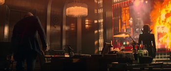 Movie still from “Black Widow” (2021), directed by Cate Shortland – A room with a desk and a large chandelier; Wide shot, Low angle
