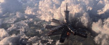 Movie still from “Black Widow” (2021), directed by Cate Shortland – An aerial view of an aircraft in the clouds; Extreme Wide shot, Overhead angle