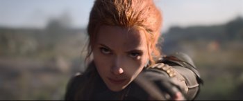 Movie still from “Black Widow” (2021), directed by Cate Shortland – A woman's face in a black outfit; Close Up shot, Low angle