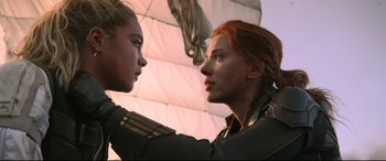 Movie still from “Black Widow” (2021), directed by Cate Shortland – A woman with red hair is looking at another woman with blonde hair; Close Up shot, Low angle