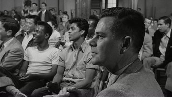 Movie still from “Blackboard Jungle” (1955), directed by Richard Brooks – Black and white photograph of men sitting in a room; Medium shot, Over the shoulder angle