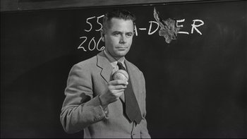 Movie still from “Blackboard Jungle” (1955), directed by Richard Brooks – A black and white photo of a man holding a ball; Medium shot, Low angle