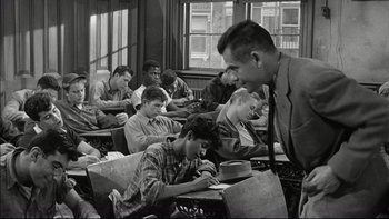 Movie still from “Blackboard Jungle” (1955), directed by Richard Brooks – Black and white photograph of students in a class room; Medium shot, High angle