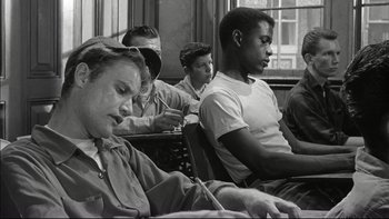 Movie still from “Blackboard Jungle” (1955), directed by Richard Brooks – Black and white photograph of people sitting in a classroom; Medium shot, High angle