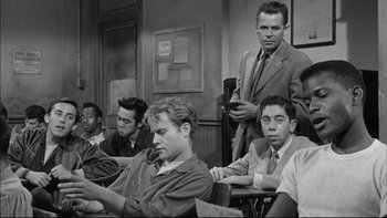 Movie still from “Blackboard Jungle” (1955), directed by Richard Brooks – Black and white photograph of men sitting in a classroom; Medium shot, High angle