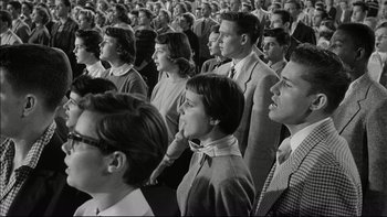 Movie still from “Blackboard Jungle” (1955), directed by Richard Brooks – A black and white photo of a group of people; Medium shot, Low angle
