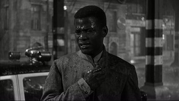 Movie still from “Blackboard Jungle” (1955), directed by Richard Brooks – A black and white photo of a man in a suit; Medium shot, Over the shoulder angle