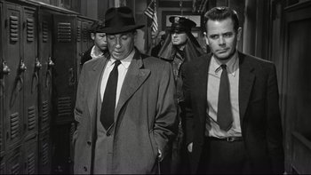 Movie still from “Blackboard Jungle” (1955), directed by Richard Brooks – A group of men walking down a street; Medium shot, Low angle