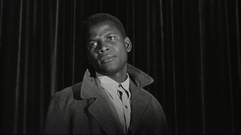 Movie still from “Blackboard Jungle” (1955), directed by Richard Brooks – A black and white photo of a man wearing a jacket; Close Up shot, Low angle