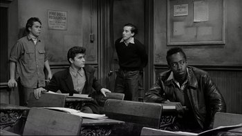 Movie still from “Blackboard Jungle” (1955), directed by Richard Brooks – A group of young men sitting at a table; Medium shot, High angle