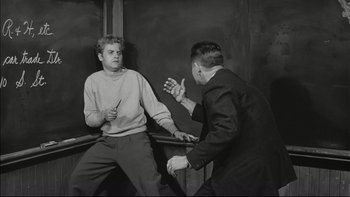 Movie still from “Blackboard Jungle” (1955), directed by Richard Brooks – Two men are having a discussion in a room; Medium shot, High angle