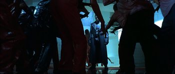 Movie still from “Blade” (1998), directed by Stephen Norrington – A group of people standing around in a room; Wide shot, Low angle