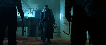 Movie still from “Blade” (1998), directed by Stephen Norrington – A man with a gun in his hand standing next to another man with an umbrella; Wide shot, Low angle