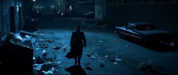 Movie still from “Blade” (1998), directed by Stephen Norrington – A man walking in the dark in a parking lot; Wide shot, High angle