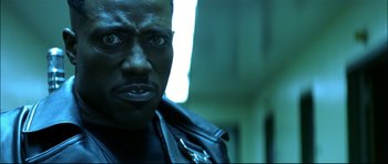 Movie still from “Blade” (1998), directed by Stephen Norrington – A person wearing a leather jacket; Close Up shot, Low angle
