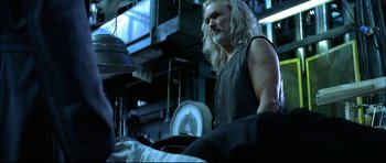 Movie still from “Blade” (1998), directed by Stephen Norrington – A man with long white hair standing in a room; Medium shot, Low angle
