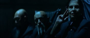 Movie still from “Blade” (1998), directed by Stephen Norrington – An old man sitting in a chair with a cigarette in his mouth; Close Up shot, Over the shoulder angle