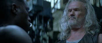 Movie still from “Blade” (1998), directed by Stephen Norrington – A man with long white hair is talking to another man; Close Up shot, Low angle