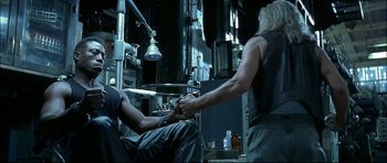 Movie still from “Blade” (1998), directed by Stephen Norrington – A man is getting his head shaved by a woman; Medium shot, Low angle