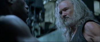 Movie still from “Blade” (1998), directed by Stephen Norrington – An old man with long white hair and a long beard; Close Up shot, Over the shoulder angle