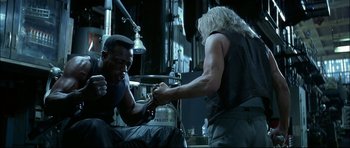 Movie still from “Blade” (1998), directed by Stephen Norrington – Two men are wrestling in a room; Medium shot, Low angle