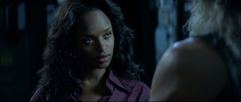 Movie still from “Blade” (1998), directed by Stephen Norrington – A woman with long black hair looking at the camera; Close Up shot, Over the shoulder angle