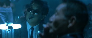 Movie still from “Blade” (1998), directed by Stephen Norrington – A man smoking a cigarette while wearing a suit and tie; Close Up shot, Low angle