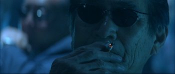 Movie still from “Blade” (1998), directed by Stephen Norrington – A man with sunglasses is smoking a cigarette; Close Up shot, Low angle