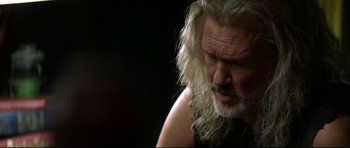 Movie still from “Blade” (1998), directed by Stephen Norrington – An older man with long white hair and a beard; Close Up shot, Low angle
