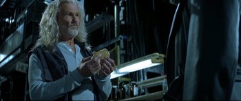 Movie still from “Blade” (1998), directed by Stephen Norrington – An older man holding a piece of food in his hands; Close Up shot, Over the shoulder angle