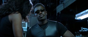 Movie still from “Blade” (1998), directed by Stephen Norrington – A man wearing sunglasses and a leather vest; Close Up shot, Low angle