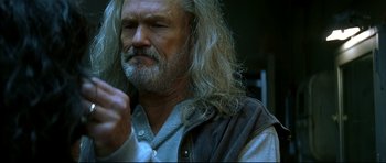 Movie still from “Blade” (1998), directed by Stephen Norrington – An older man with long hair and a beard; Close Up shot, Low angle