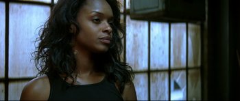 Movie still from “Blade” (1998), directed by Stephen Norrington – A beautiful young woman with long black curly hair; Close Up shot, Low angle