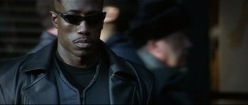 Movie still from “Blade” (1998), directed by Stephen Norrington – A person wearing sunglasses and a jacket; Close Up shot, Low angle