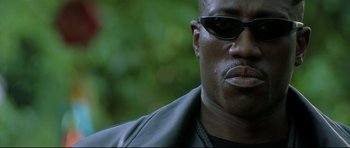Movie still from “Blade” (1998), directed by Stephen Norrington – A person wearing sunglasses; Close Up shot, Low angle