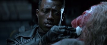 Movie still from “Blade” (1998), directed by Stephen Norrington – A person wearing a leather jacket; Close Up shot, High angle