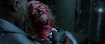 Movie still from “Blade” (1998), directed by Stephen Norrington – A man with blood all over his face and neck; Close Up shot, Low angle