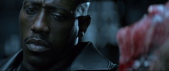 Movie still from “Blade” (1998), directed by Stephen Norrington – A man's face in the dark; Close Up shot, Low angle