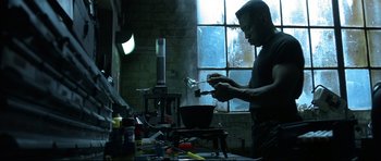 Movie still from “Blade” (1998), directed by Stephen Norrington – A man is cooking something in a pot on a stove; Medium shot, Low angle
