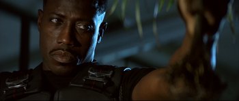 Movie still from “Blade” (1998), directed by Stephen Norrington – A man's face with a camera in his hand; Close Up shot, Low angle