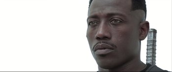 Movie still from “Blade” (1998), directed by Stephen Norrington – A man's face with a white background; Close Up shot, Low angle