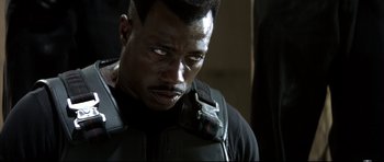 Movie still from “Blade” (1998), directed by Stephen Norrington – A person with a cell phone on his shoulder; Close Up shot, Over the shoulder angle
