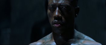 Movie still from “Blade” (1998), directed by Stephen Norrington – A person with tattoos on his face; Close Up shot, High angle