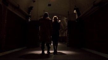 Movie still from “Blade II” (2002), directed by Guillermo del Toro – Two people are walking in a dark tunnel; Wide shot, Low angle